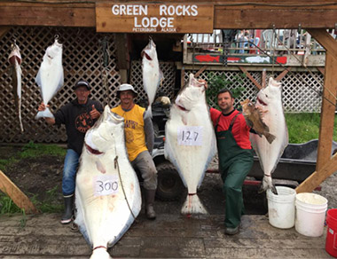 fishermen holding halibut